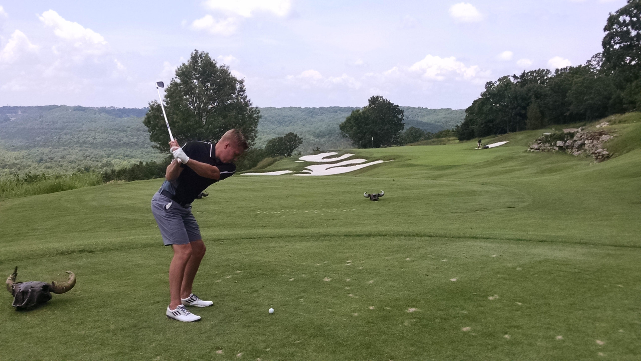 Golfer teeing off